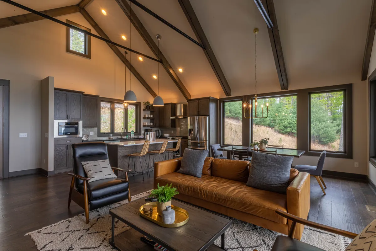 This image features a stylish, contemporary kitchen and dining area with a quartz-topped island, spacious dining table, and large windows providing abundant natural light. The modern fixtures and open layout make it an ideal spot for family breakfasts or entertaining guests, echoing the section's emphasis on communal meals and gatherings.